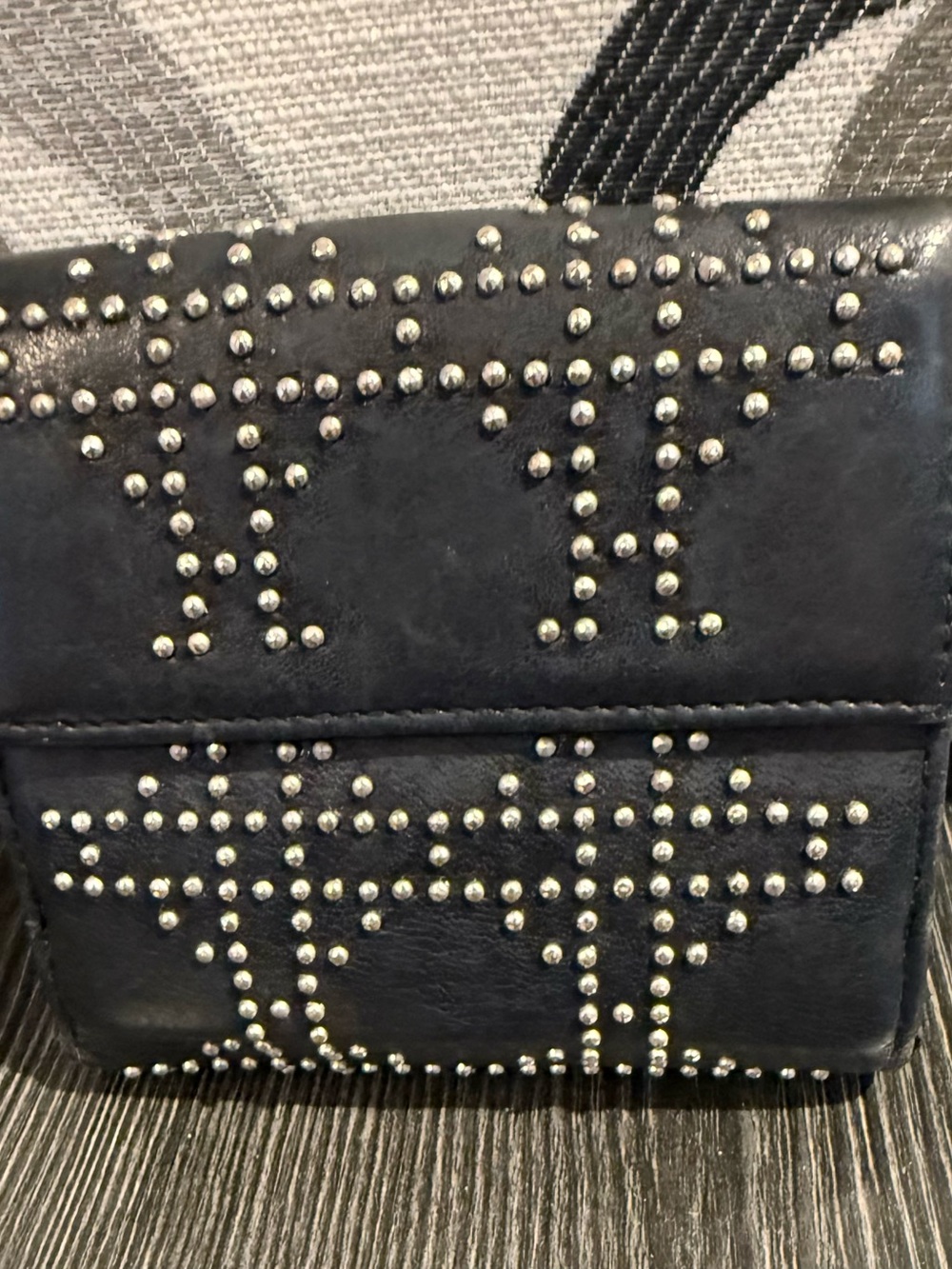 Christian Dior studded black compact wallet.